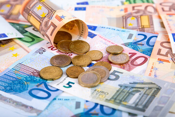 Background of banknotes and euro coins of different denominations close-up