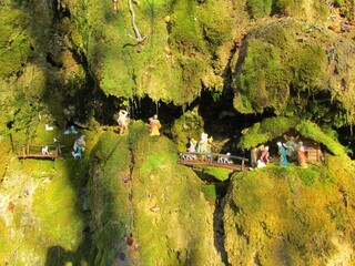 Nativity scene, manger scene, crib, crèche made in natural environment on moss covered rocks with...