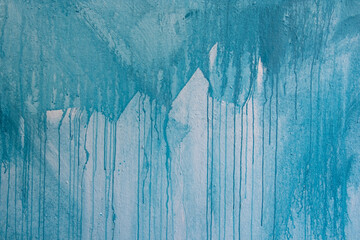 horizontal color pattern texture photograph of turquoise blue paint dripping down a white wall....
