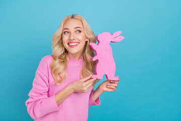 Photo of funky millennial curly blond lady hold bunny wear pink jumper isolated on blue color...