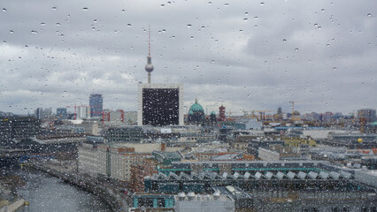 View on Berlin and tv tower on a rainy day. Shot taken from Bundestag building, raindrops on the window