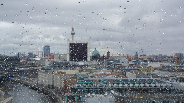 View on Berlin and tv tower on a rainy day. Shot taken from Bundestag building, raindrops on the window - Powered by Adobe