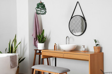 Interior of light bathroom with sink, mirror and bench © Pixel-Shot