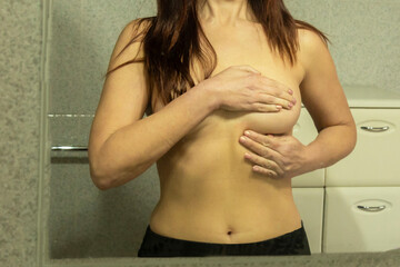 Woman doing breast self-exam to prevent cancer