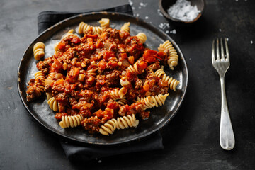 Pasta bolognese with vegetables on plate
