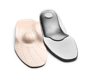 Beige orthopedic insoles on white background
