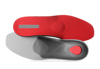 Red orthopedic insoles on white background