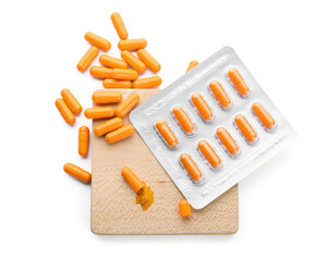 Blister pack with turmeric powder capsules on white background