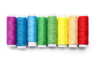Multicolored sewing thread spools on white background
