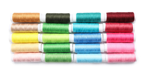Multicolored sewing thread spools on white background