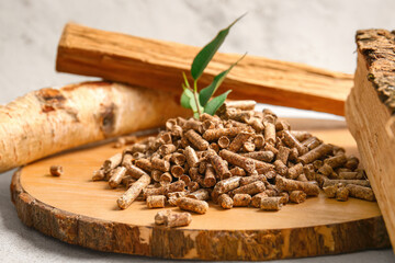 Board with pile of wood pellets on table, closeup