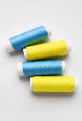 Different thread spools on white background
