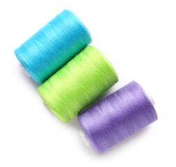 Different thread spools on white background