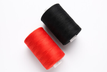 Different thread spools on white background