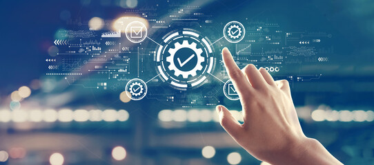 Quality control approval with hand pressing a button on a technology screen