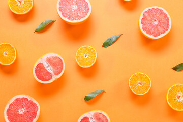 Fresh orange and grapefruit slices on color background