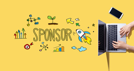 Sponsor with person working with a laptop