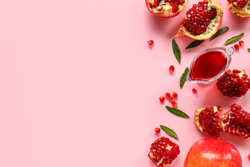 Tasty ripe pomegranate pieces and gravy boat with jam on pink background