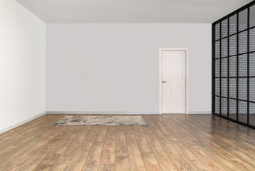View of big empty room with door and carpet