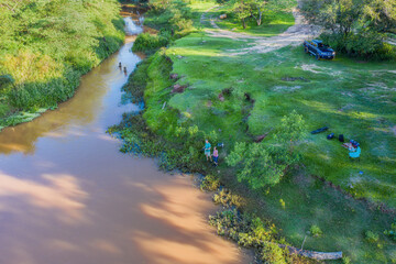 Aerial view of a man and woman fishing on the Tebicuary River in Paraguay.
