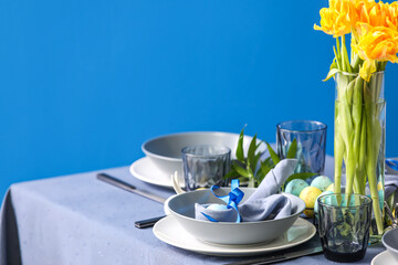 Table served for Easter celebration near blue wall