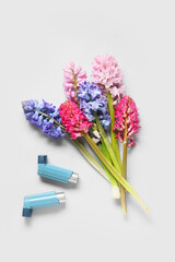Bouquet of beautiful hyacinth flowers and inhalers on white background