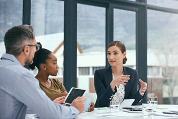 Formulating new ways to do business. Cropped shot of a group of colleagues having a meeting in an...