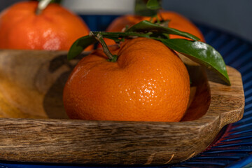 Fototapeta na wymiar basket of Orange tangerines in wooden bowl