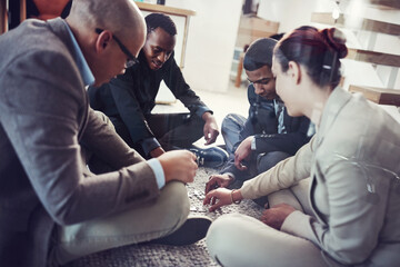 Obraz premium Finding solutions together. Cropped shot of a group of coworkers putting a puzzle together.