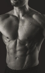 Male torso. Close-up of chest and abs muscles. Black and white photo. Banner poster.