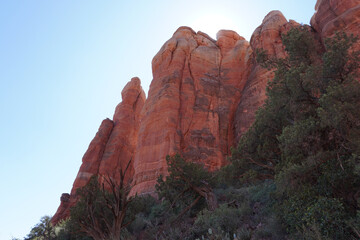 Scenic view of deserted red rocks covered with green shrubs and trees in Sedona, Arizona