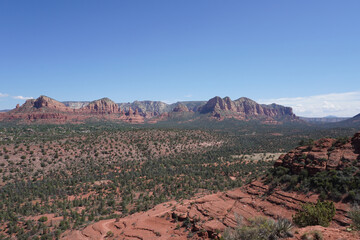 Scenic view of deserted red rocks covered with green shrubs in Sedona, Arizona