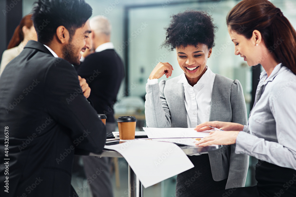 Aufkleber everybody is on the same page. shot of a group of businesspeople talking together while sitting at a