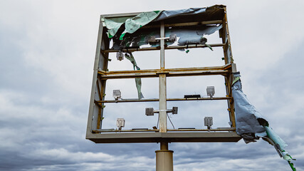 Broken sign after storm in the wind