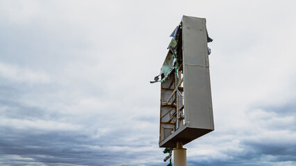 Broken sign after storm in the wind