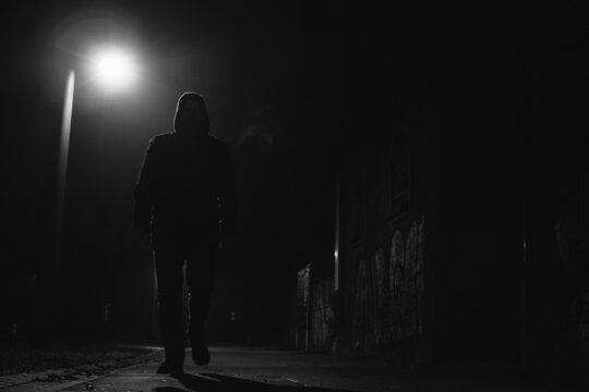 Lonely Man Walking Outside At Night