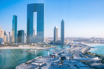 Beautiful modern skyscrapers with beach against clear blue sky