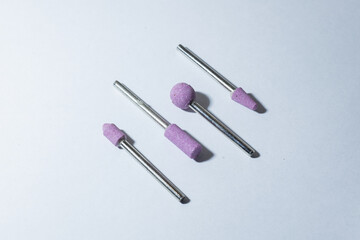 Closeup of ceramic nail drill bits on a white surface