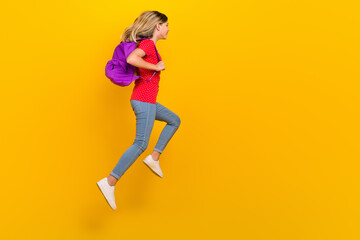 Fototapeta na wymiar Full size profile side photo of young lady hold backpack travel hiking isolated over yellow color background