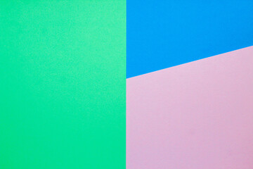 Abstract background with colored paper blue with pink and green color.