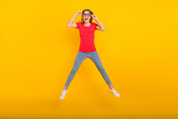 Fototapeta na wymiar Full body photo of young excited girl have fun jump up energetic eyewear isolated over yellow color background
