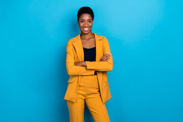 Portrait of positive lady folded arms toothy smile look camera isolated on blue color background