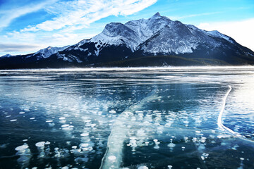 Beautiful view of frozen Abraham lake in background of snow covered mountains