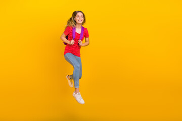 Fototapeta na wymiar Full size photo of young pretty girl jump bag lesson look empty space isolated over yellow color background