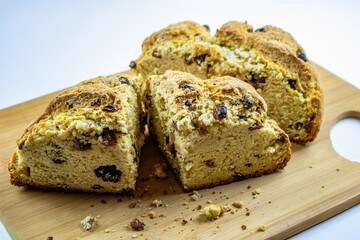 Freshly baked Irish soda bread set on a wooden cutting board.