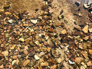 View of small rocks and pebbles seen through the water