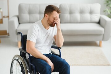 Depression and loneliness in disabled man. Elderly man in wheelchair crying indoors