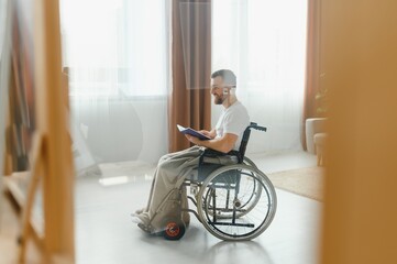 Fototapeta na wymiar Young handsome man in wheelchair