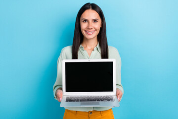 Portrait of gorgeous young businesswoman promote you new working laptop sale discount isolated on blue color background