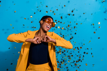 Photo of cool overjoyed person have good mood fly air star confetti isolated on blue color background - Powered by Adobe
